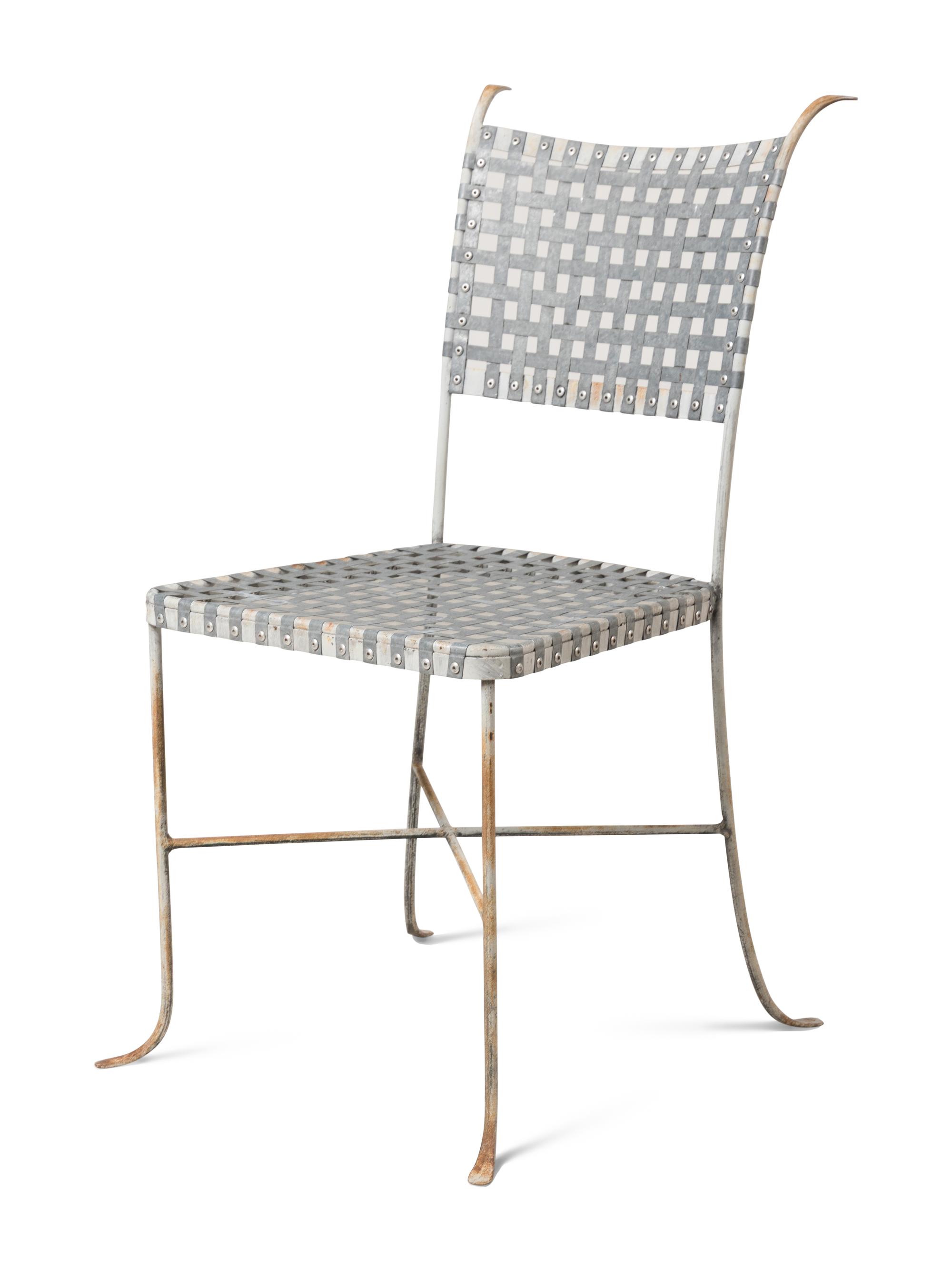 A Painted Metal Garden Table and a Set of Four Woven Metal Garden Chairs