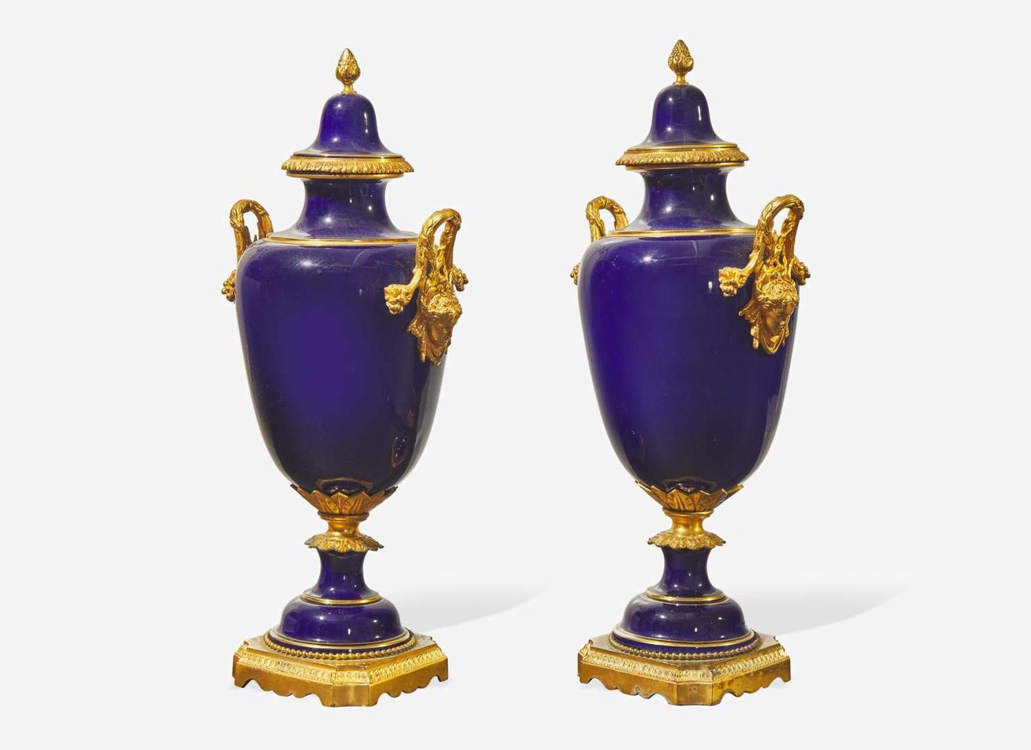 A pair of French gilt bronze mounted cobalt blue porcelain urns, late 19th / early 20th century