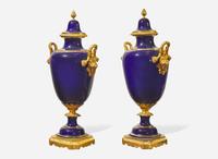 A pair of French gilt bronze mounted cobalt blue porcelain urns, late 19th / early 20th century