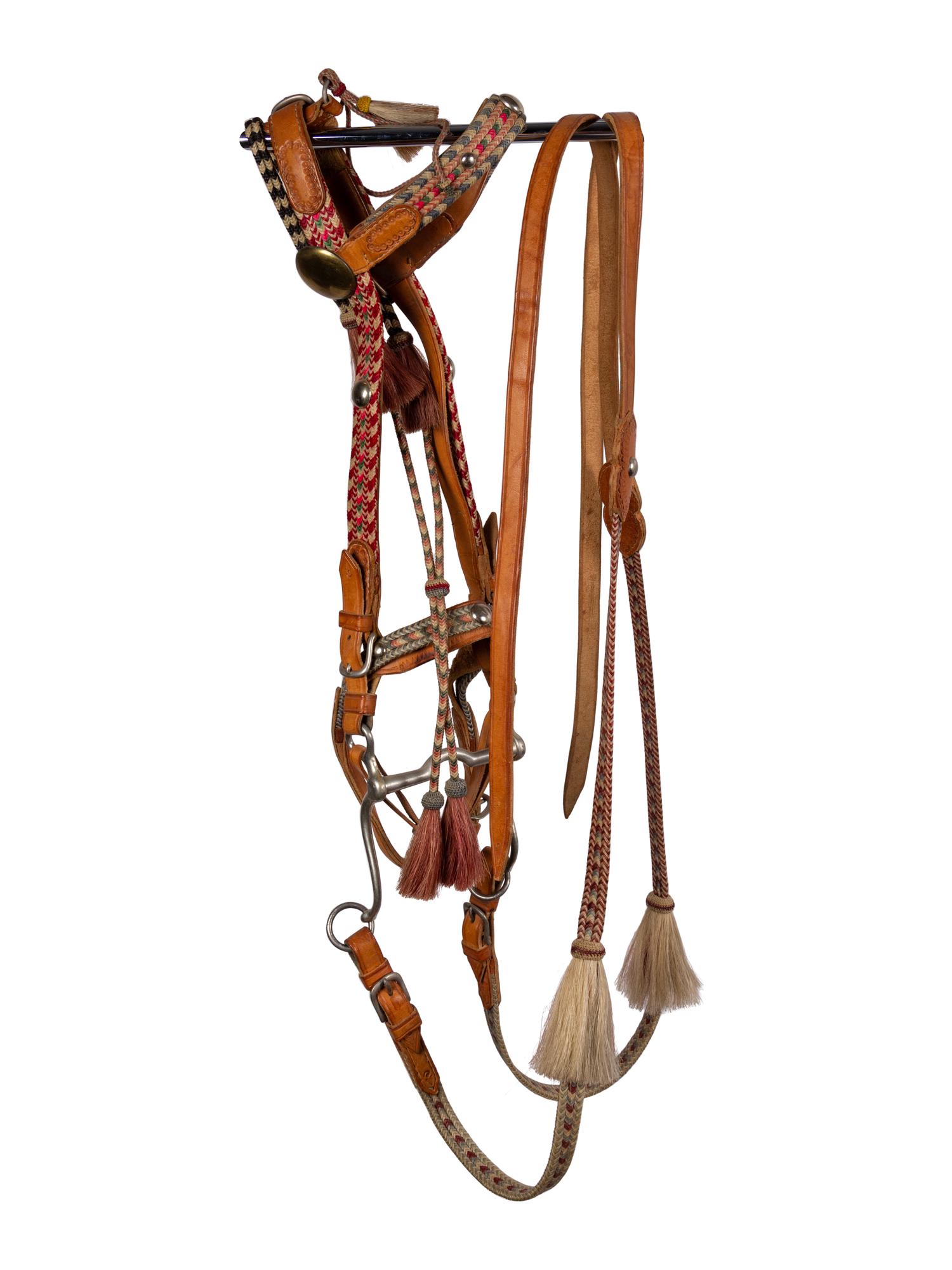 A Group of Western Horse Bridles and Quirts