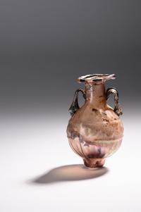 A Sidonian Mold-Blown Aubergine Glass Flask with Tendril Scrolls