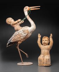 A Folk Art Carved and Painted Wood Figural Group of a Stork and Two Babies