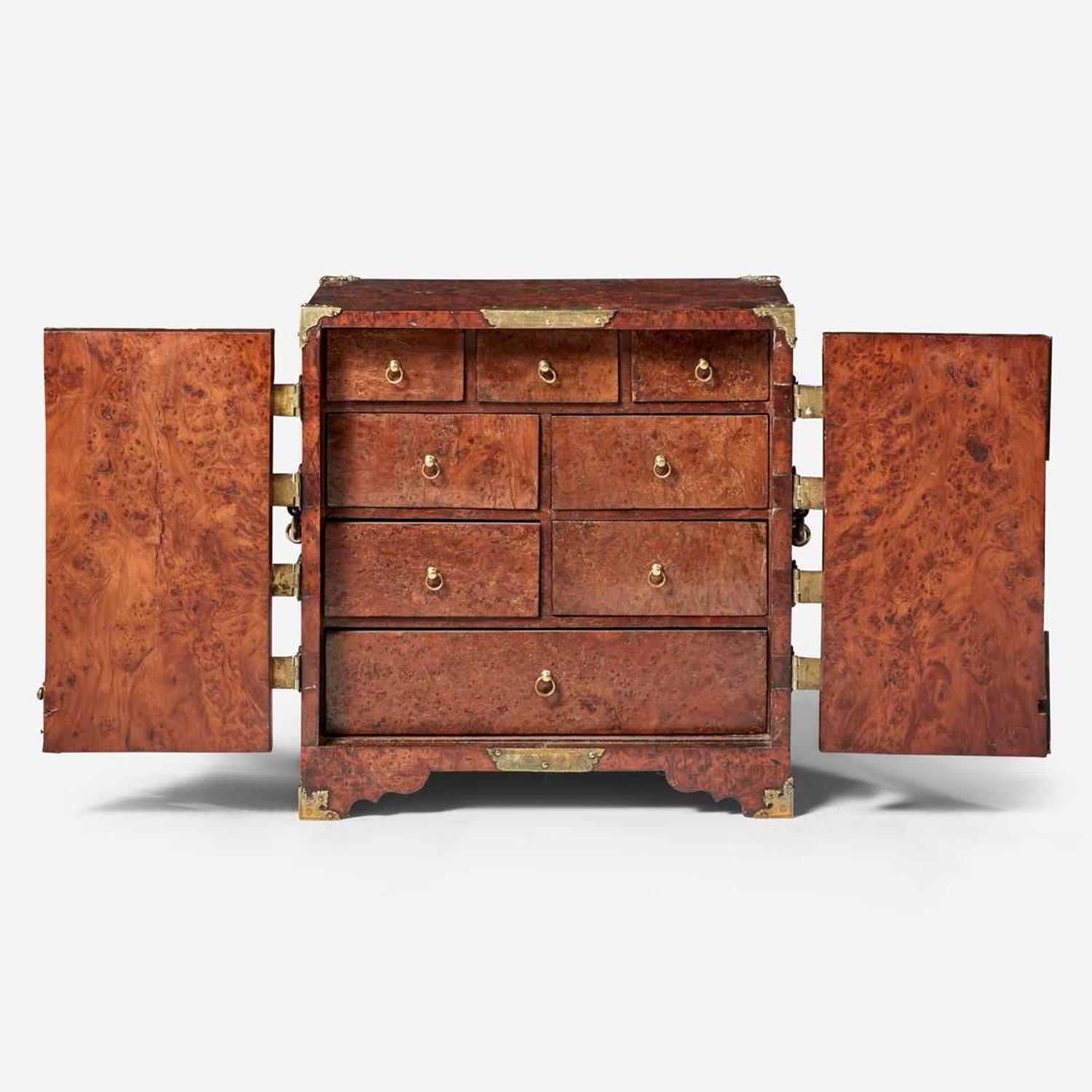 A Queen Anne brass-mounted burl yew table cabinet circa 1710