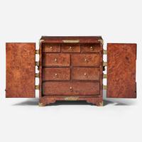 A Queen Anne brass-mounted burl yew table cabinet circa 1710