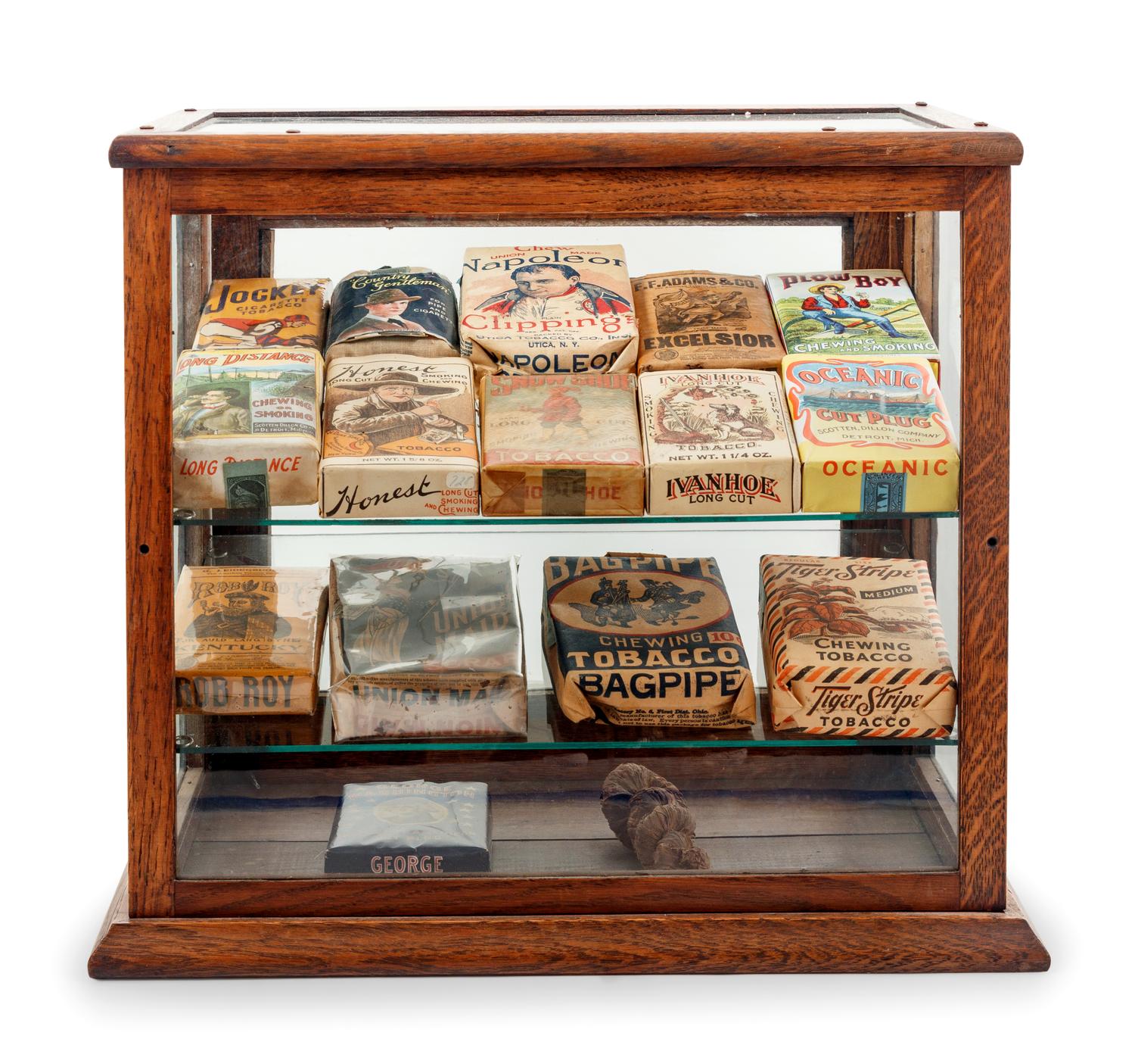 A Collection of Fifteen Tobacco Cartons and a Tobacco Rope in Display Case