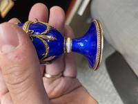 A 14 Karat Vari-Color Gold, Guilloché Enamel, Diamond, and Cabochon Jewel-Mounted Egg-Form Perfume and a Related Guilloché Enamel, 14 Karat Vari-Color Gold, Diamond, and Cabochon-Mounted Surprise Egg