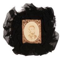 [LINCOLN, Abraham (1809-1865)]. Lincoln mourning cockade with albumen photograph at center.