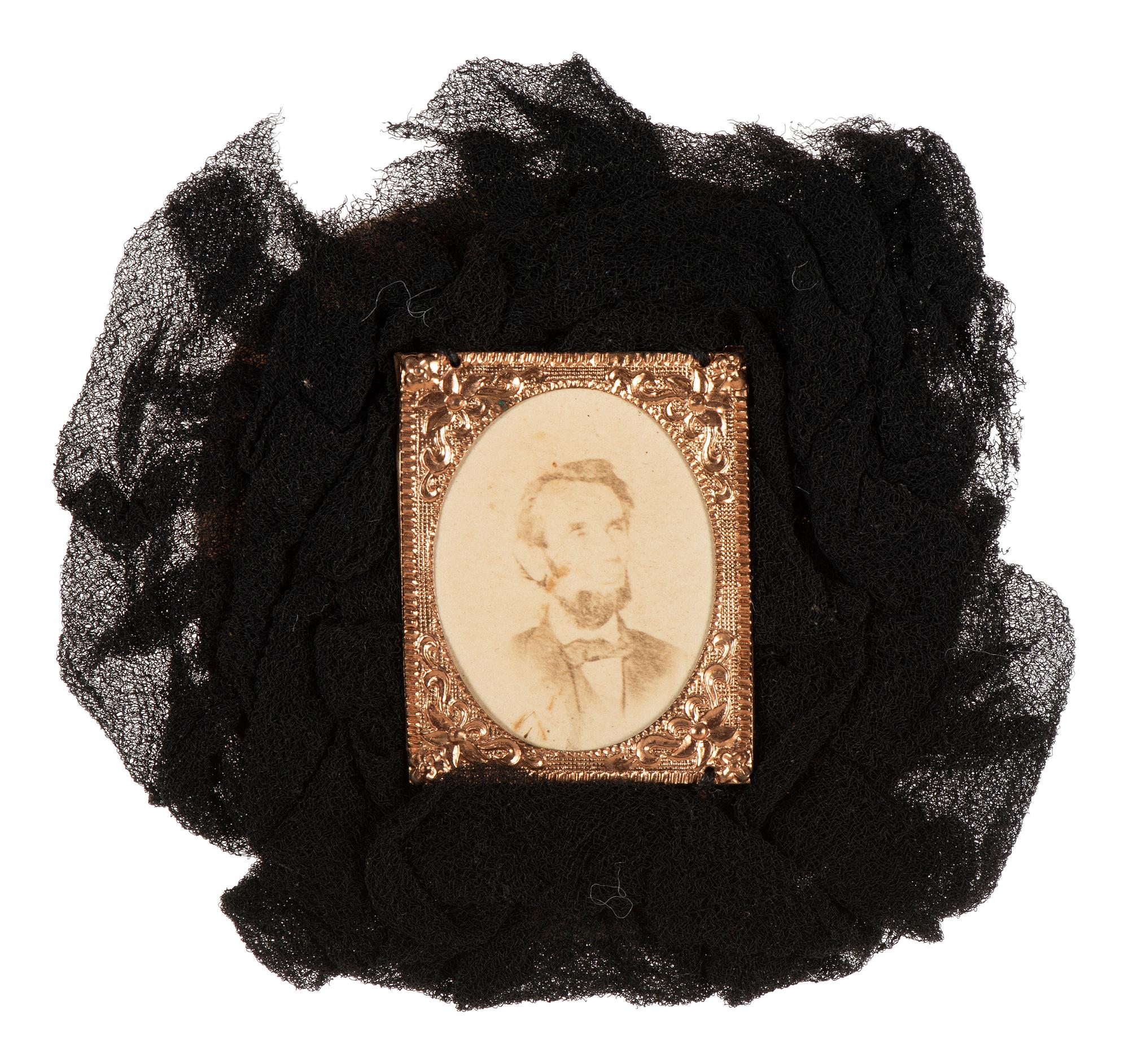 [LINCOLN, Abraham (1809-1865)]. Lincoln mourning cockade with albumen photograph at center.