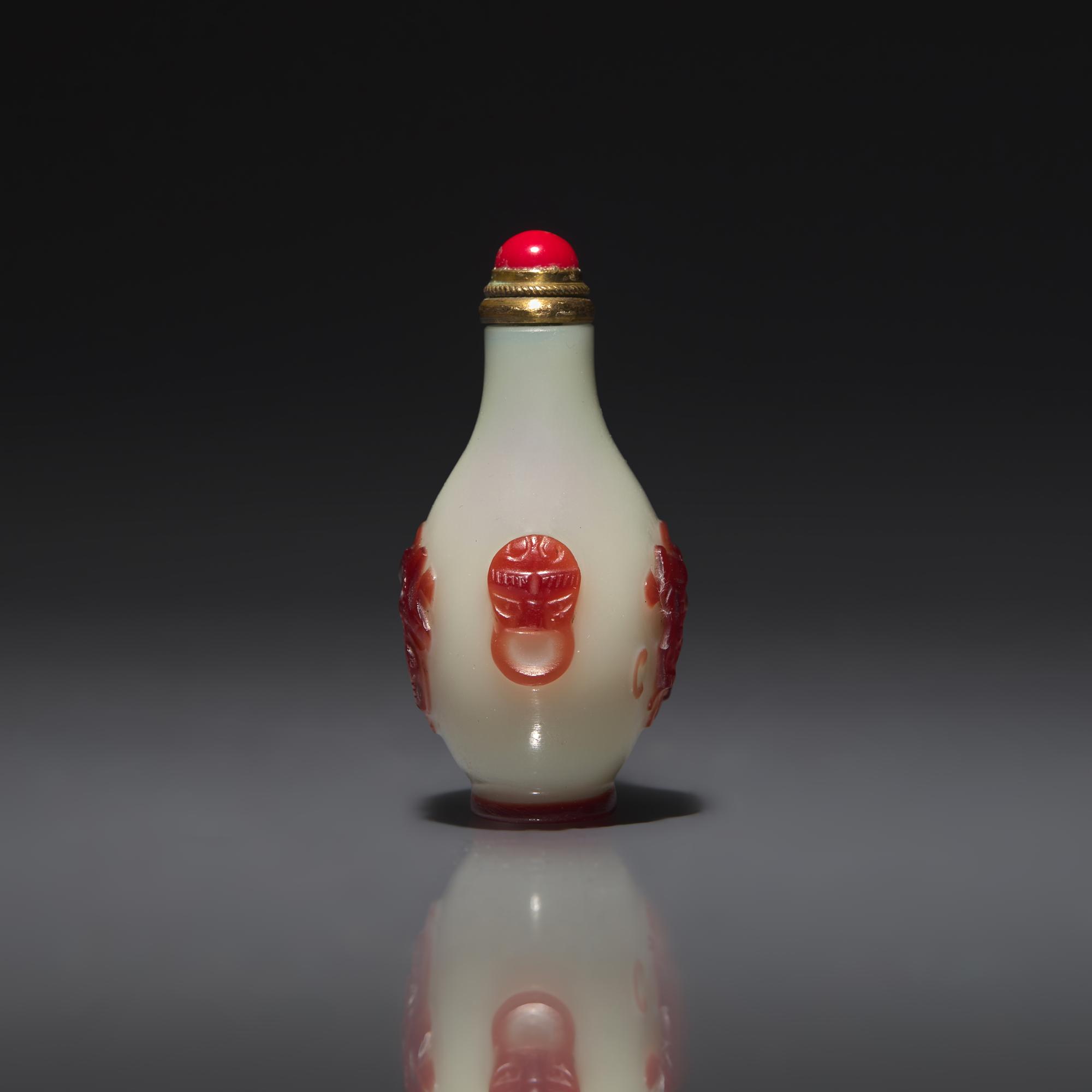 A Chinese Miniature Red-Overlaid Opaline Glass Snuff Bottle, Circa 1750-1820 1750-1820年 涅白地套寶石紅料螭龍紋小鼻烟壺