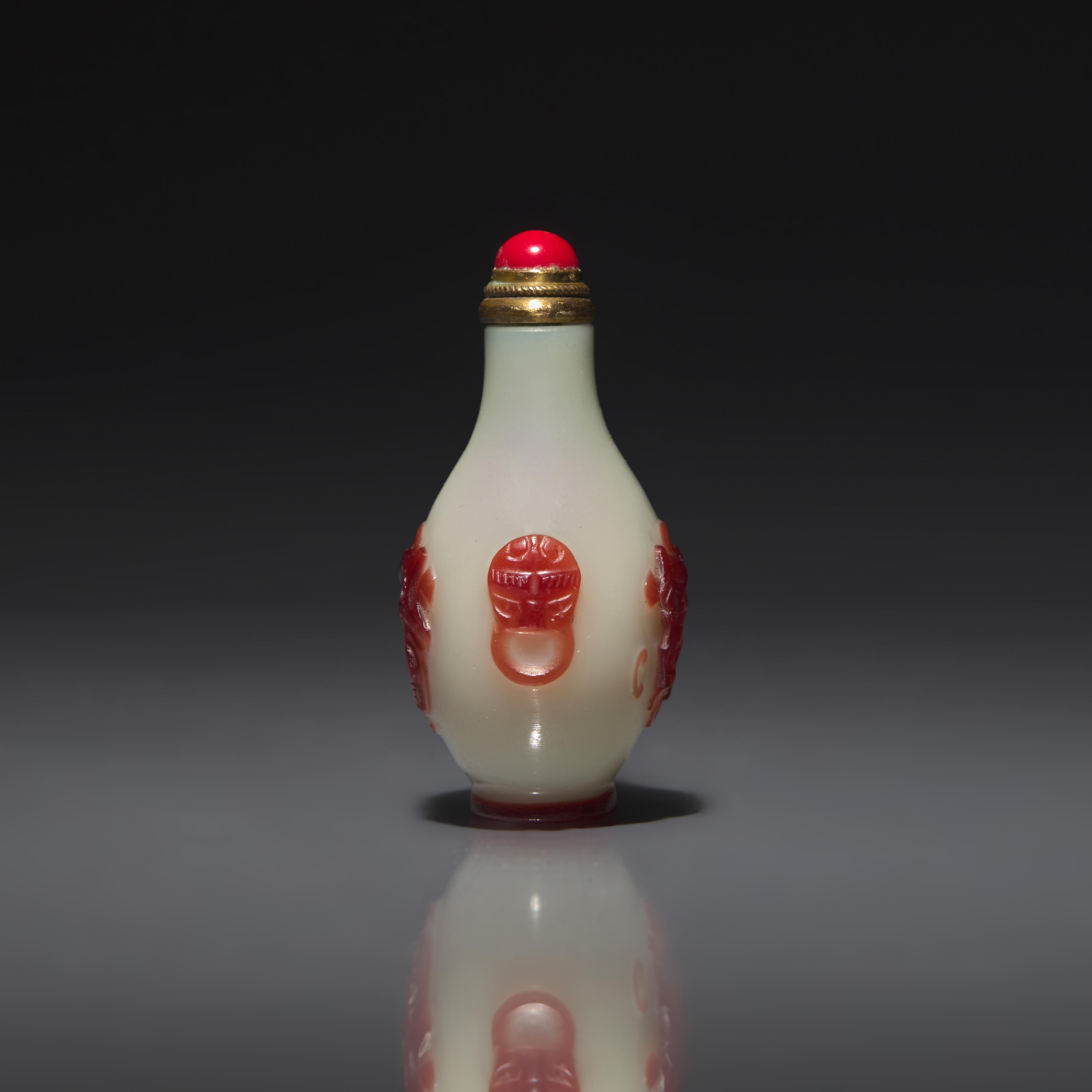 A Chinese Miniature Red-Overlaid Opaline Glass Snuff Bottle, Circa 1750-1820 1750-1820年 涅白地套寶石紅料螭龍紋小鼻烟壺