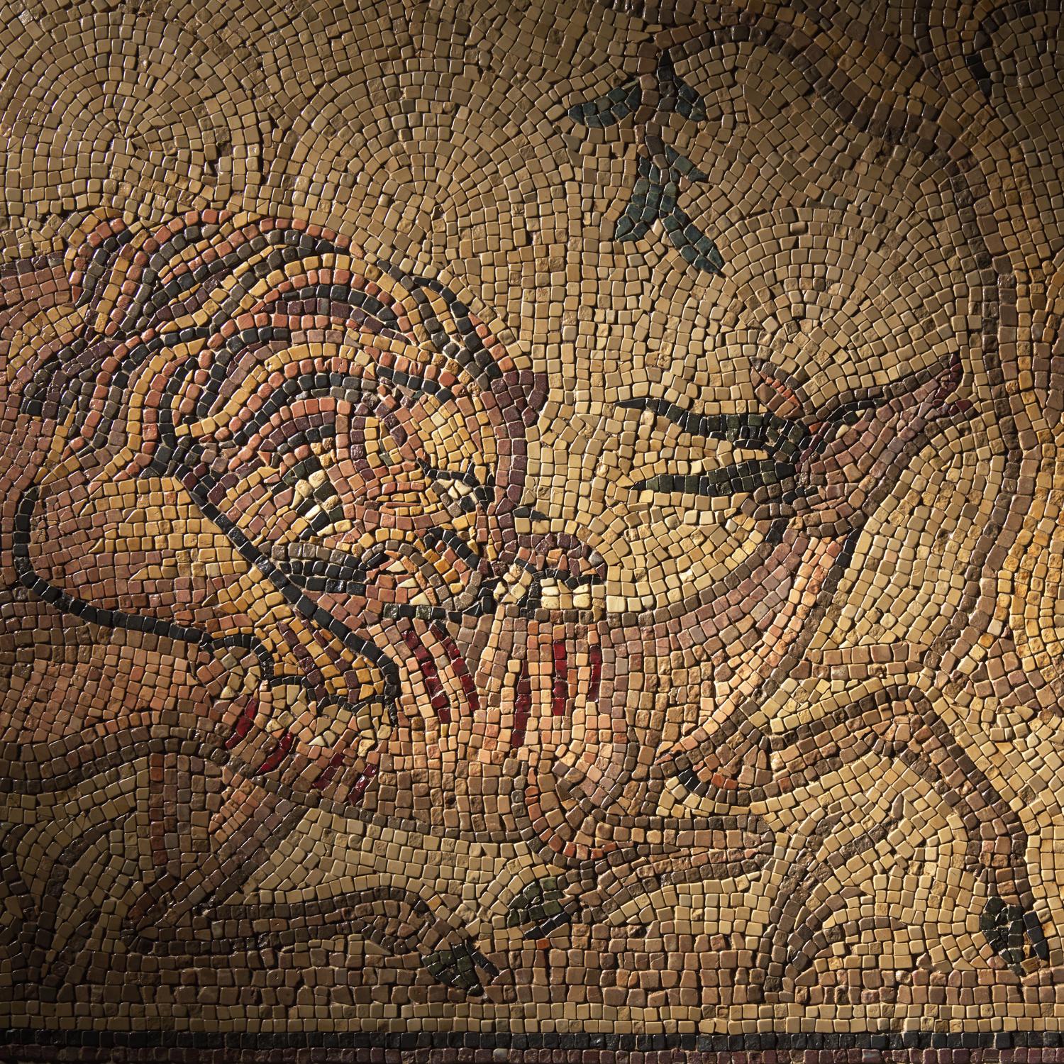 A Roman Style Stone Mosaic Panel with a Lion Hunting Prey
