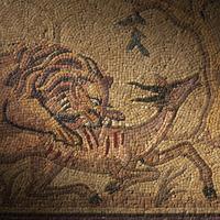 A Roman Style Stone Mosaic Panel with a Lion Hunting Prey
