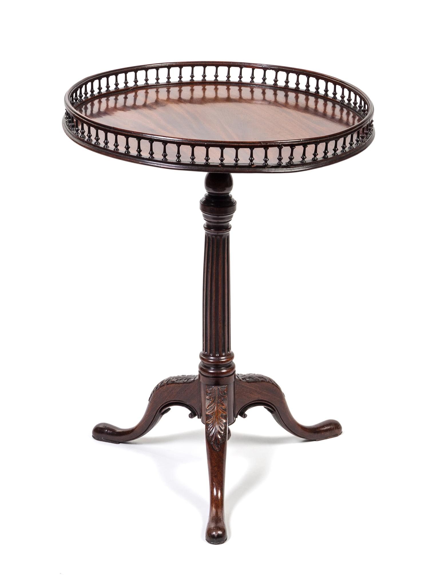 A George III Mahogany Tea Table Height 30 1/2 x diameter 22 1/2 inches.
