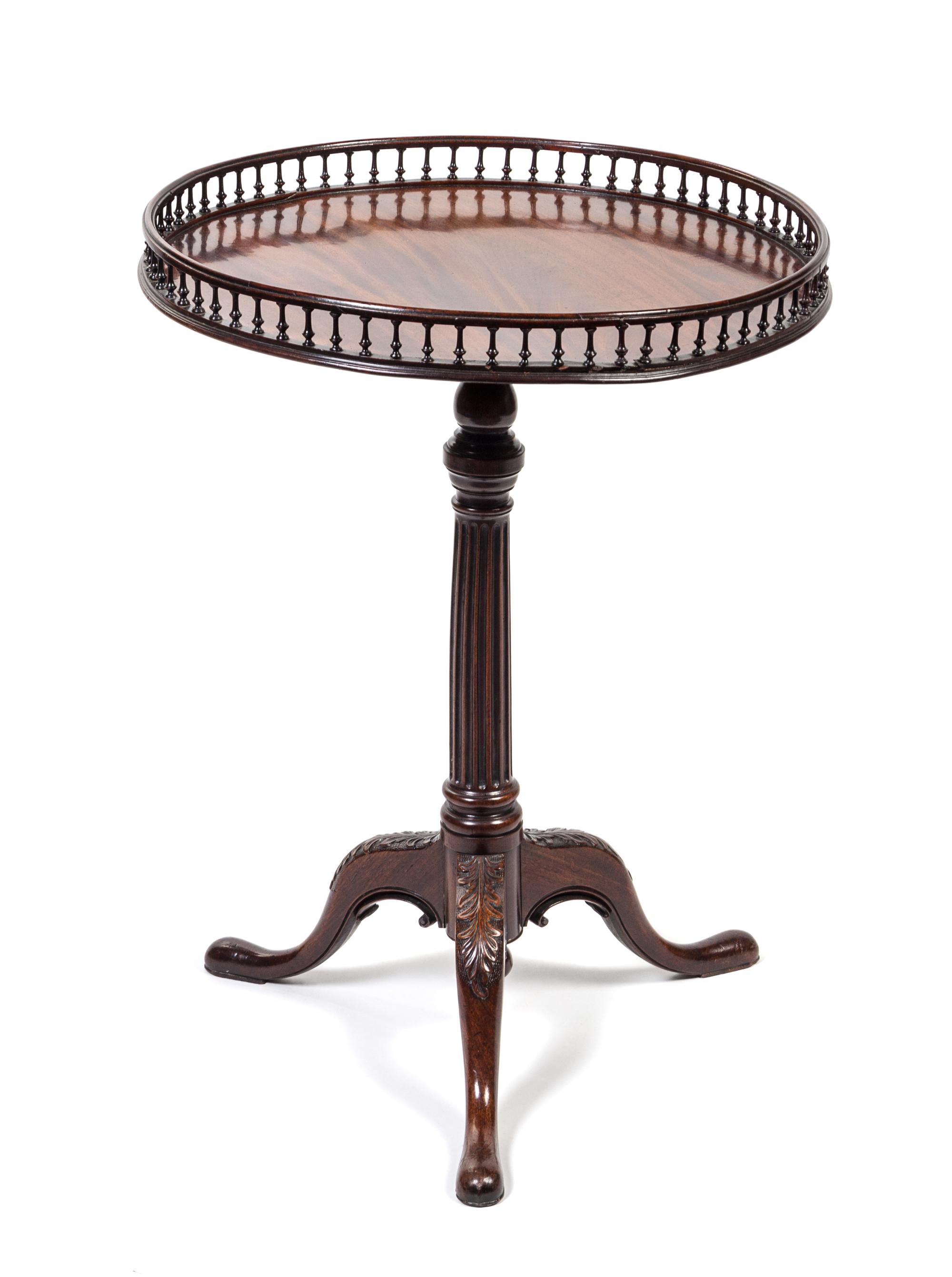 A George III Mahogany Tea Table Height 30 1/2 x diameter 22 1/2 inches.