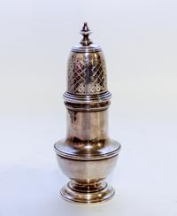 An English Silver Muffineer, Marshall Field & Co., London, 1948, having an urn finial surmounting a baluster form body.