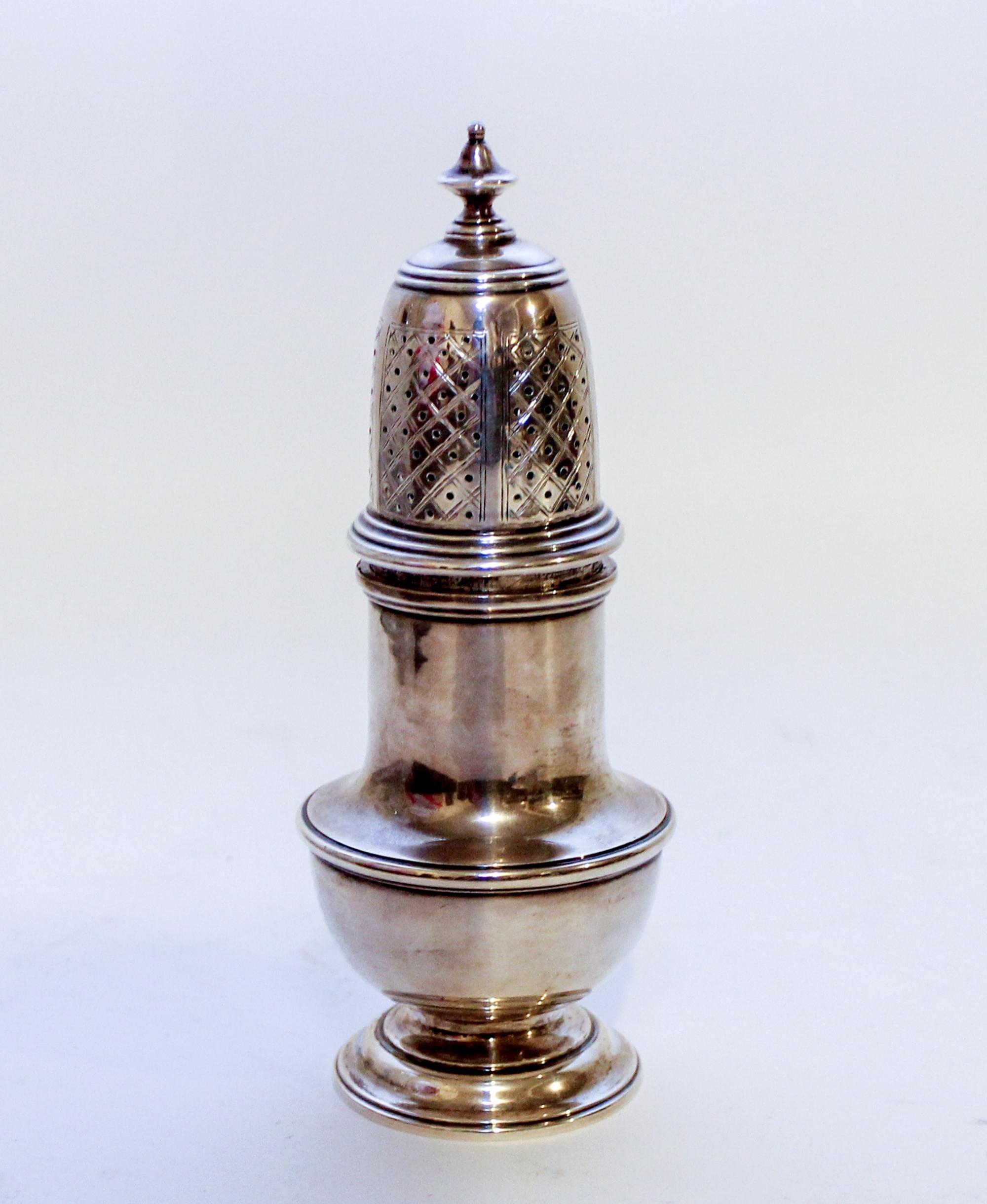An English Silver Muffineer, Marshall Field & Co., London, 1948, having an urn finial surmounting a baluster form body.