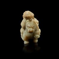 A Chinese greyish white jade carving of a foreigner on a mythical beast 18th Century or earlier