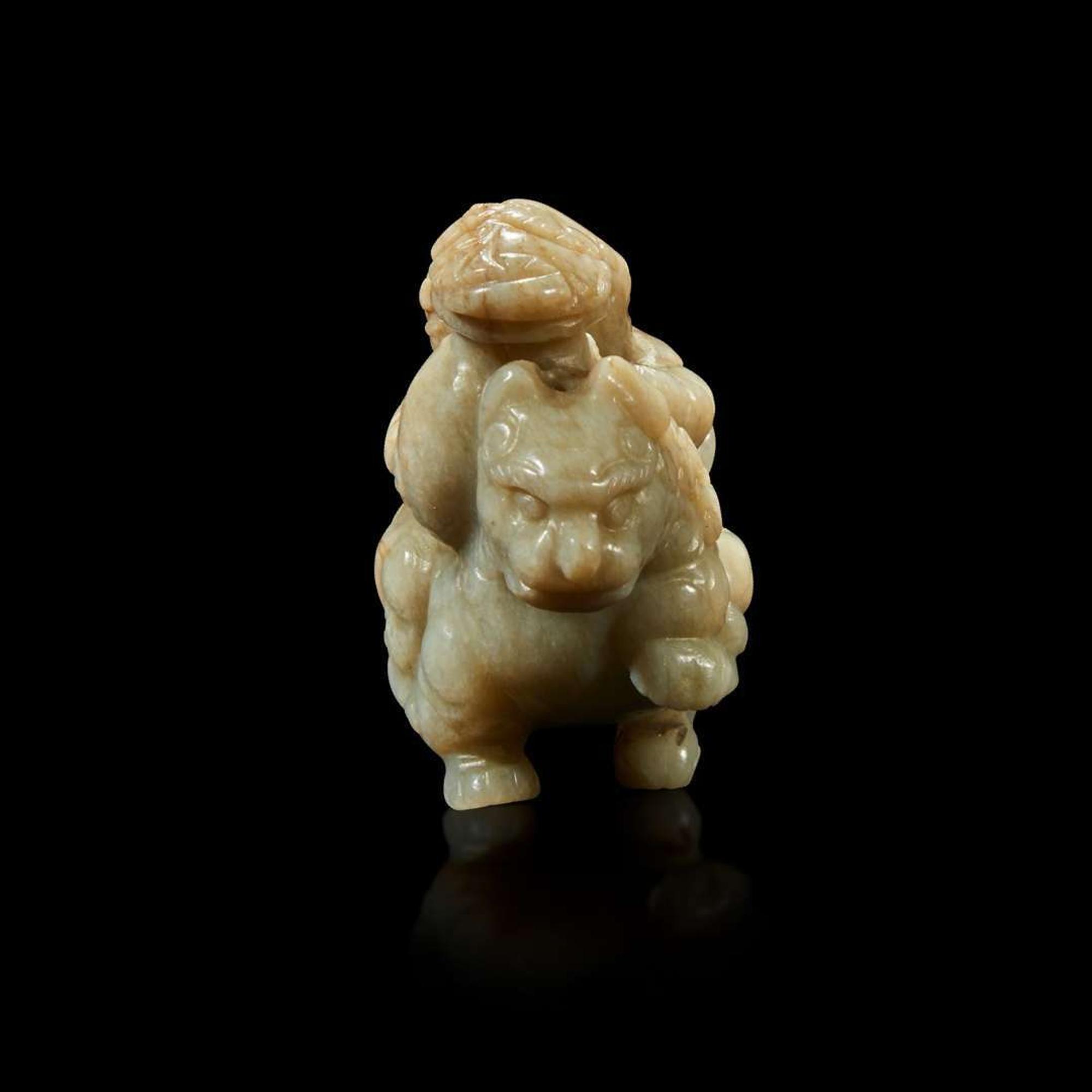 A Chinese greyish white jade carving of a foreigner on a mythical beast 18th Century or earlier