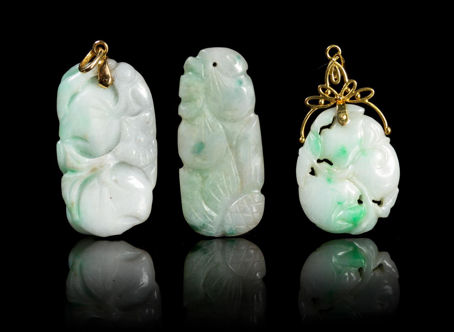 Three Carved Jadeite Pendants Height of largest 1 3/4 inches.