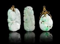 Three Carved Jadeite Pendants Height of largest 1 3/4 inches.