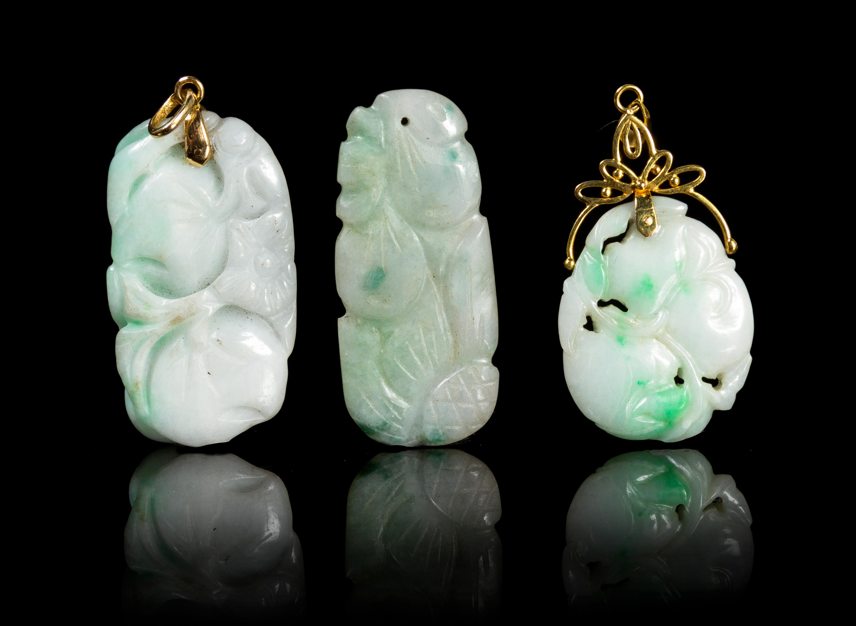 Three Carved Jadeite Pendants Height of largest 1 3/4 inches.