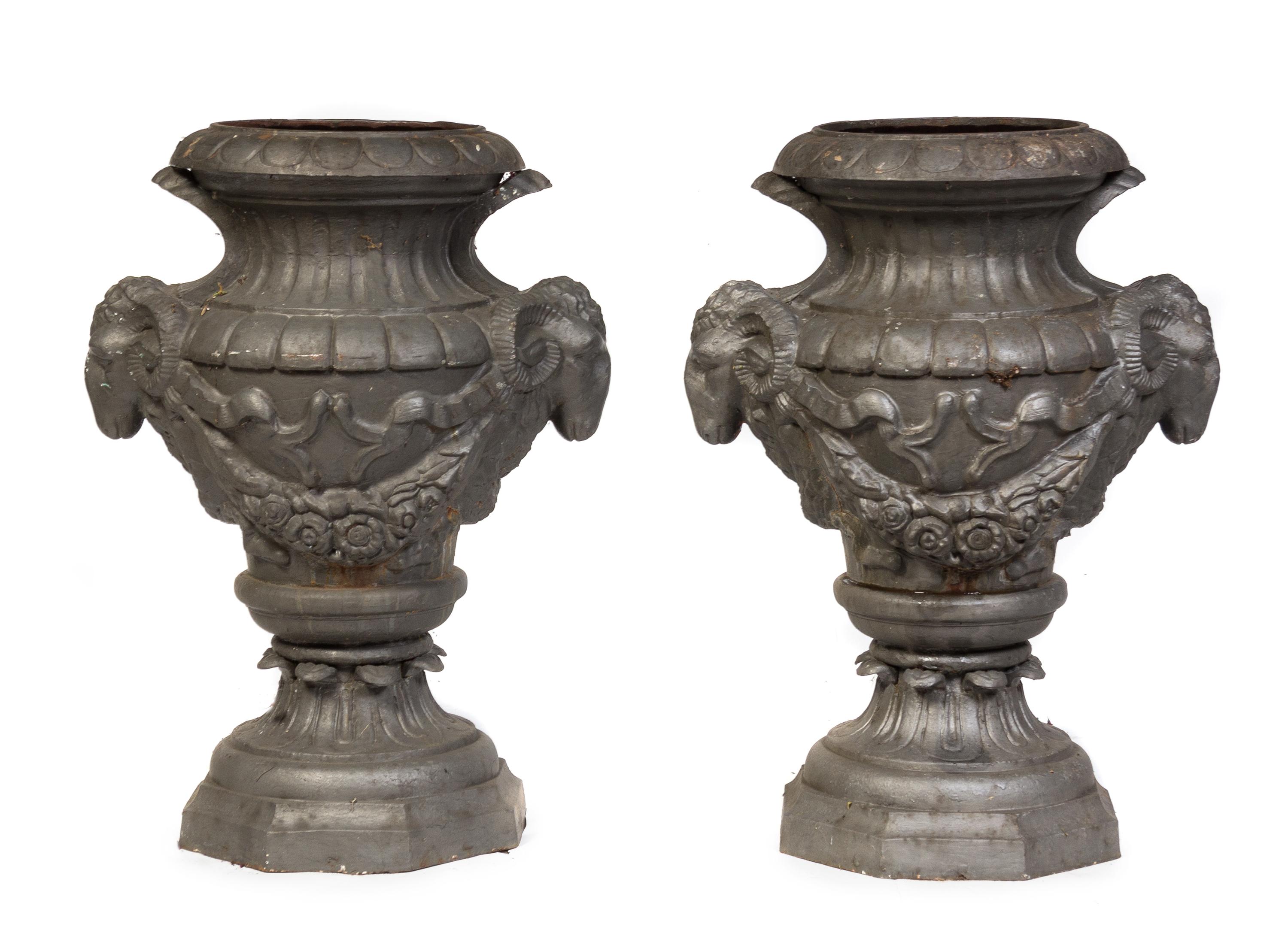 A Pair of Neoclassical Cast Metal Garden Urns Height 34 inches.