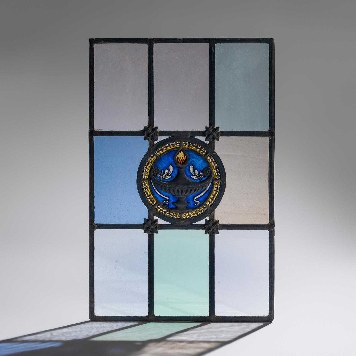 Window with cast metal lamp in circular medallion