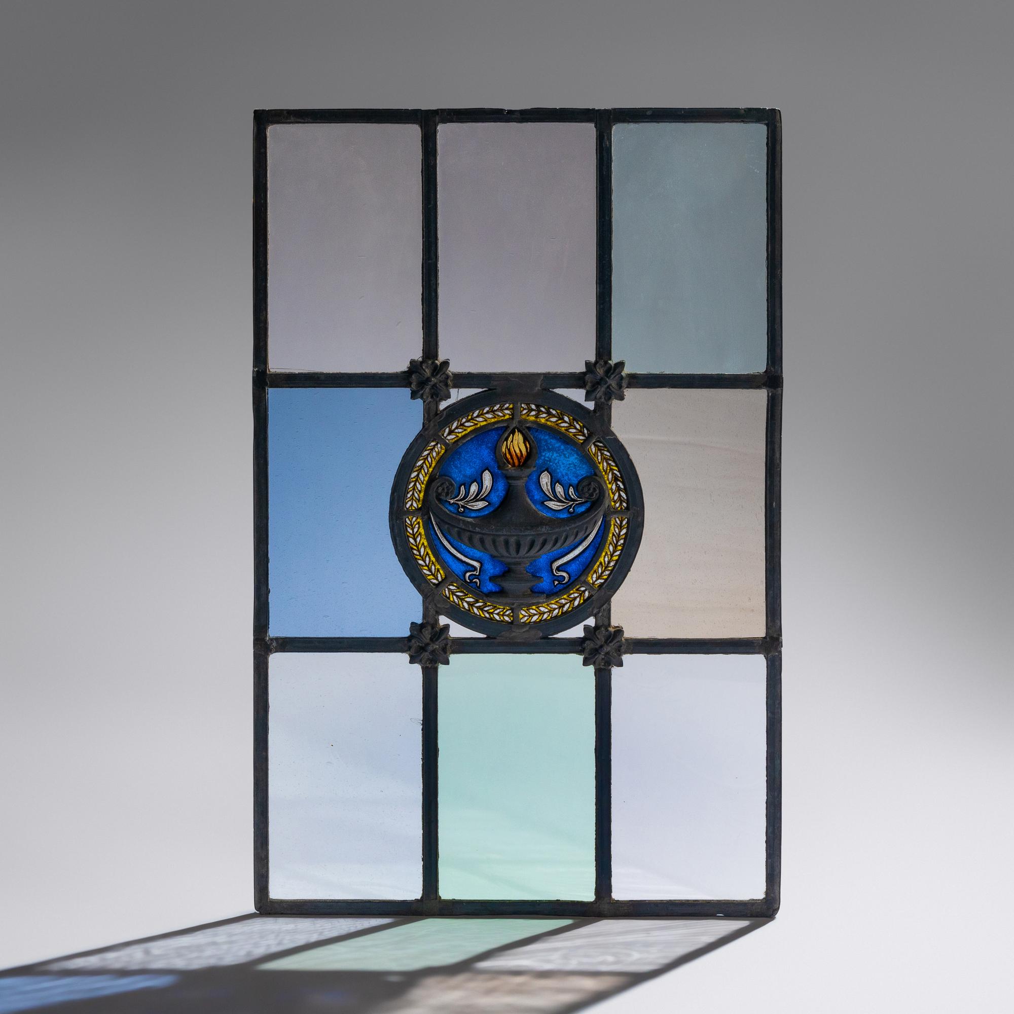 Window with cast metal lamp in circular medallion