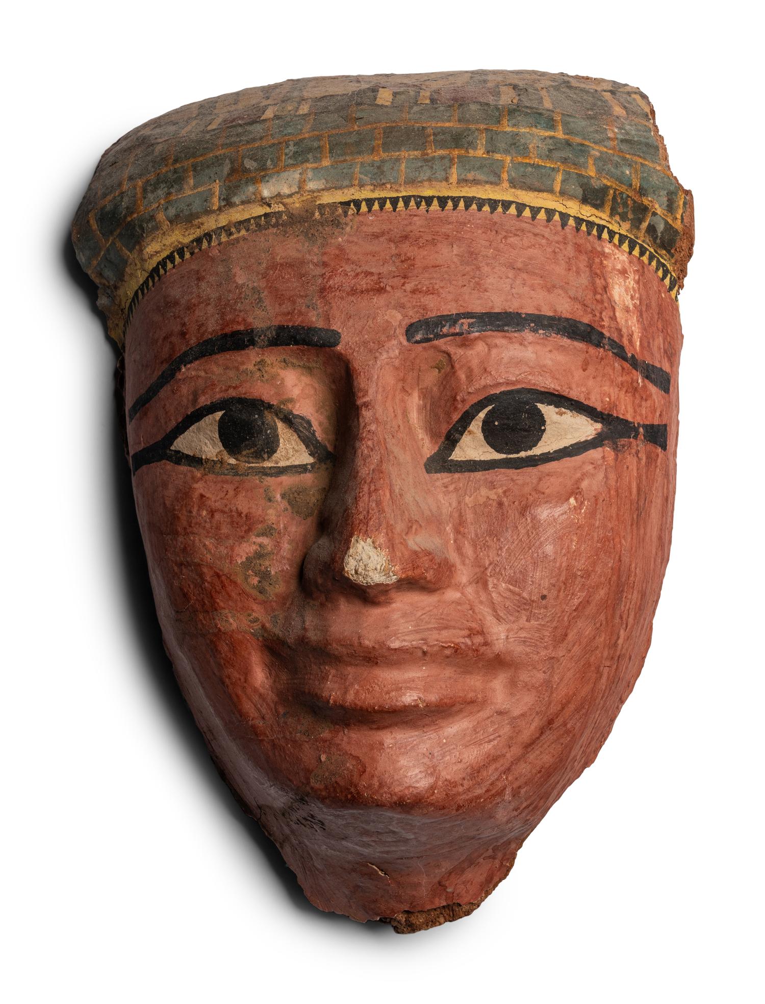 An Egyptian Wood and Painted Cartonnage Mummy Mask