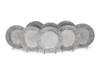 A Set of Eight S. Kirk and Son Repousse Silver Bread Plates