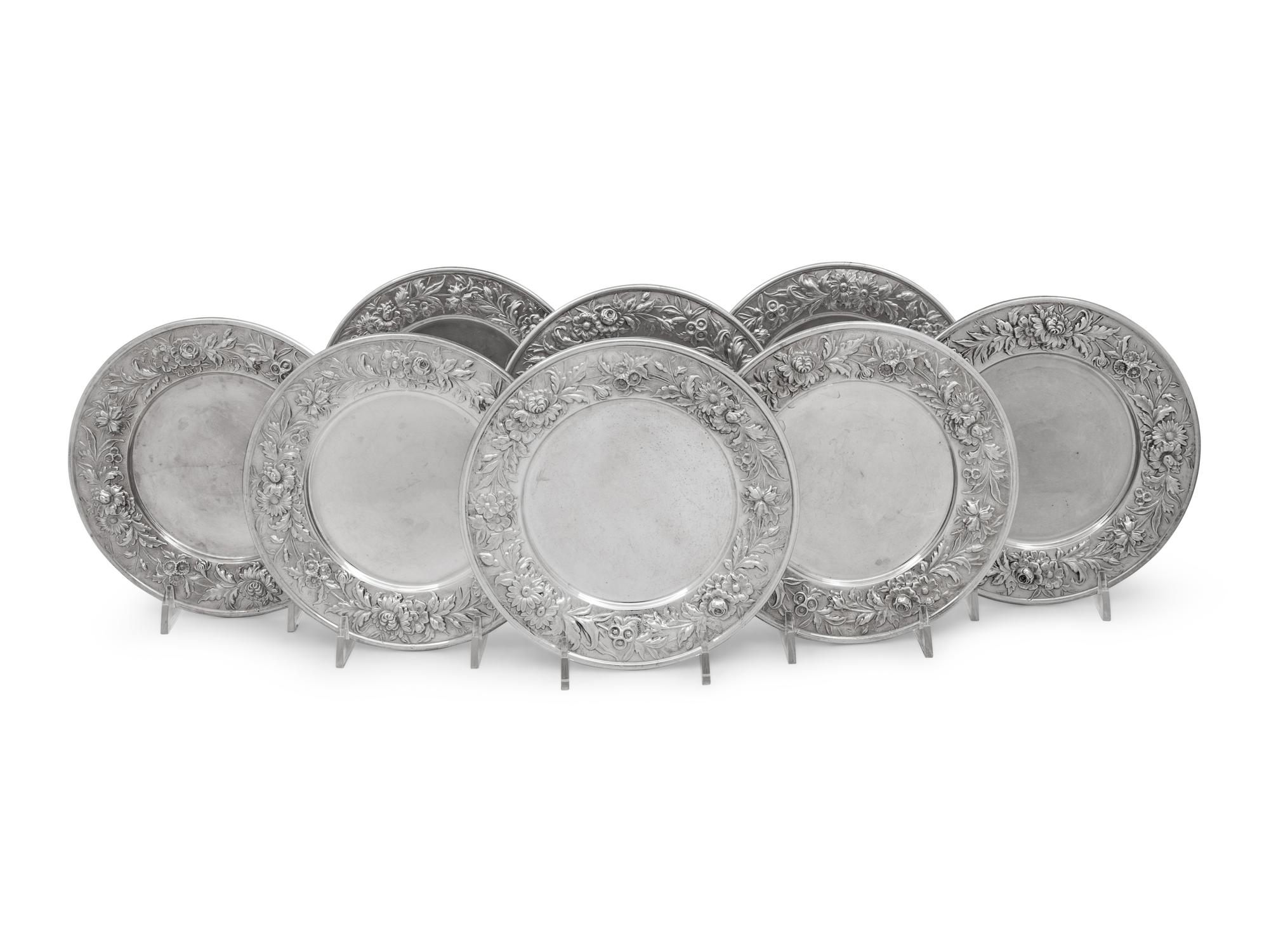 A Set of Eight S. Kirk and Son Repousse Silver Bread Plates