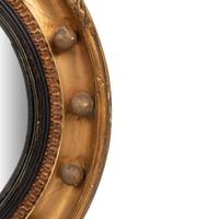 A Regency Giltwood and Part Ebonized Bullseye Mirror
