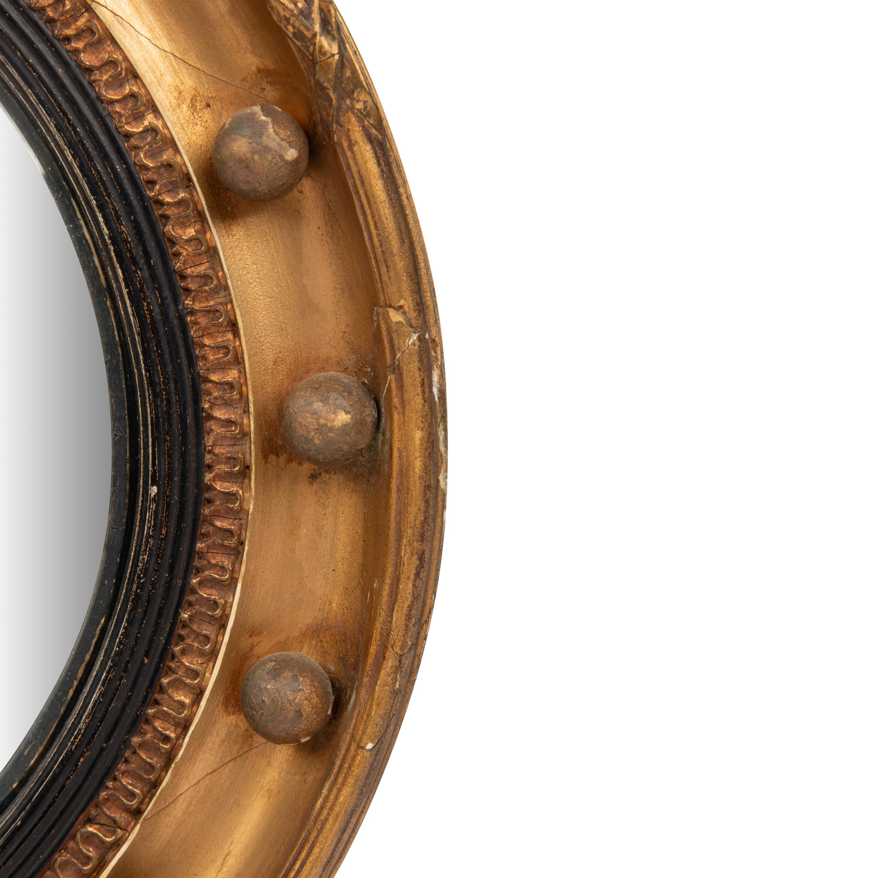 A Regency Giltwood and Part Ebonized Bullseye Mirror