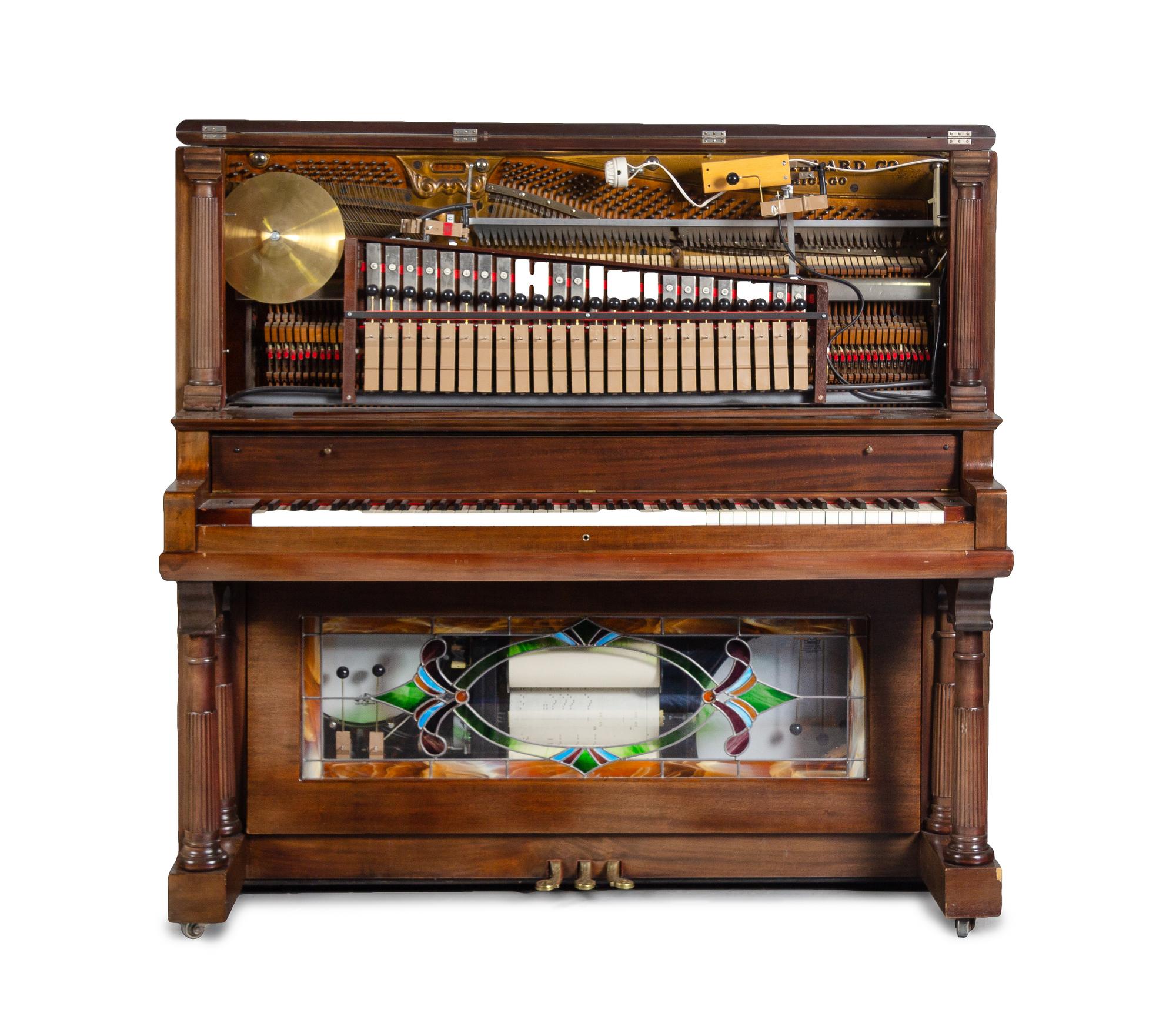 An American Mahogany and Leaded Glass Mounted Orchestrion with an Upholstered Bench