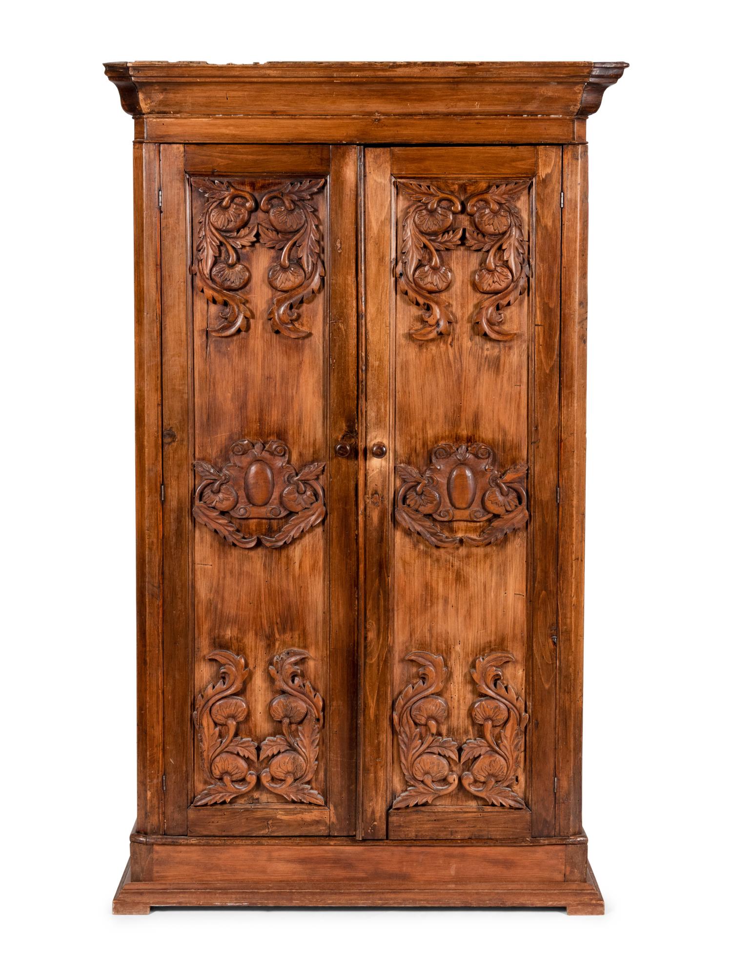 A Mexican Carved Walnut Wardrobe Cabinet