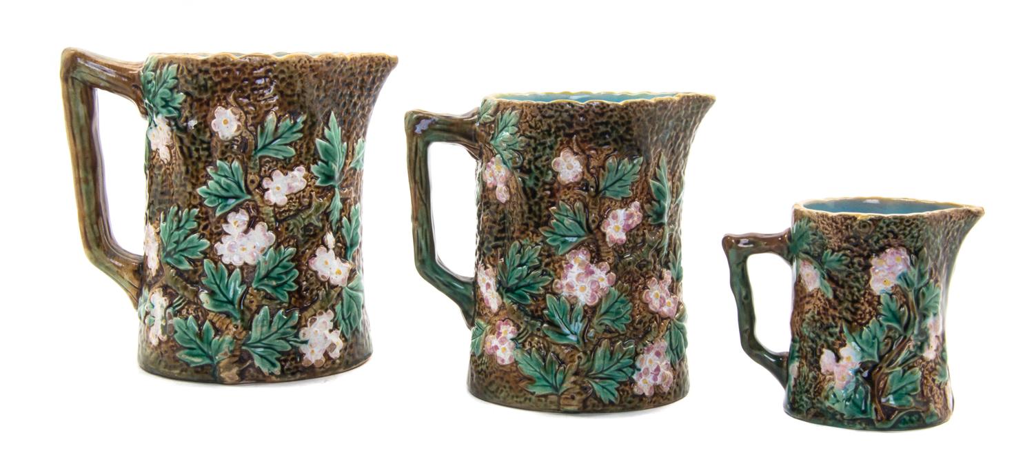 A Set of Three Majolica Pitchers, Height of tallest 5 3/8 inches.