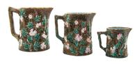 A Set of Three Majolica Pitchers, Height of tallest 5 3/8 inches.
