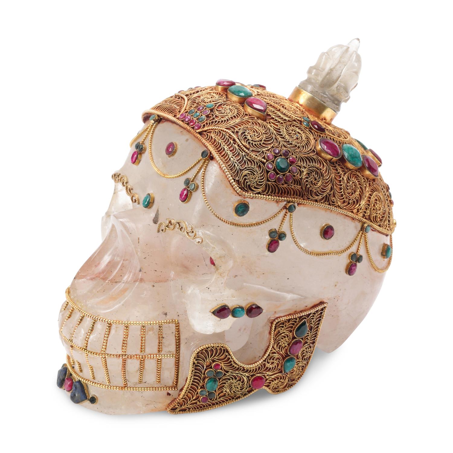 An Emerald, Ruby and Silver Filigree Mounted Rock Crystal Skull