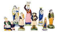 A Collection of Eight Quimper Pottery Figures Height of tallest 7 1/2 inches.