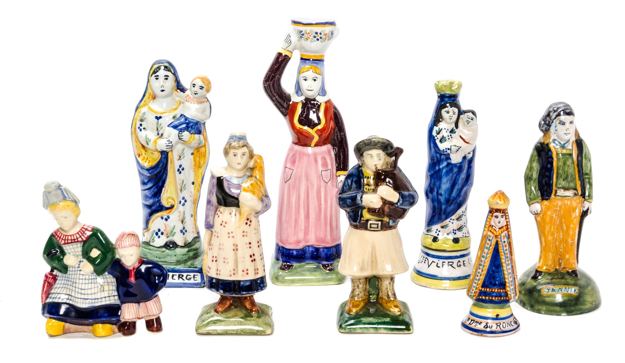 A Collection of Eight Quimper Pottery Figures Height of tallest 7 1/2 inches.