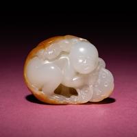A Chinese Russet and White Jade Carving of a Boy with Lotus Pad, 18th/19th Century — 清中期 白玉留皮童子持荷把件