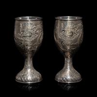 A Pair of Chinese Export Silver 'Dragon' Wine Cups, 20th Century 近代 外銷鏨云龍紋酒杯一對