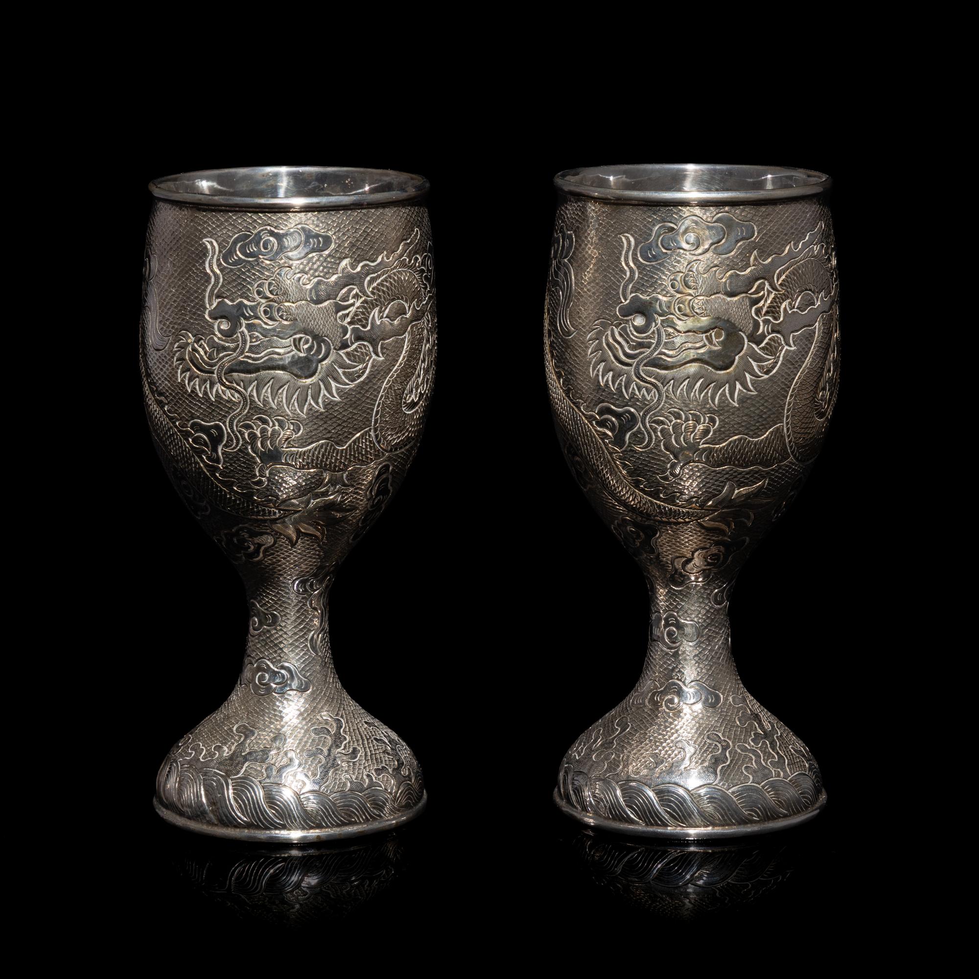 A Pair of Chinese Export Silver 'Dragon' Wine Cups, 20th Century 近代 外銷鏨云龍紋酒杯一對