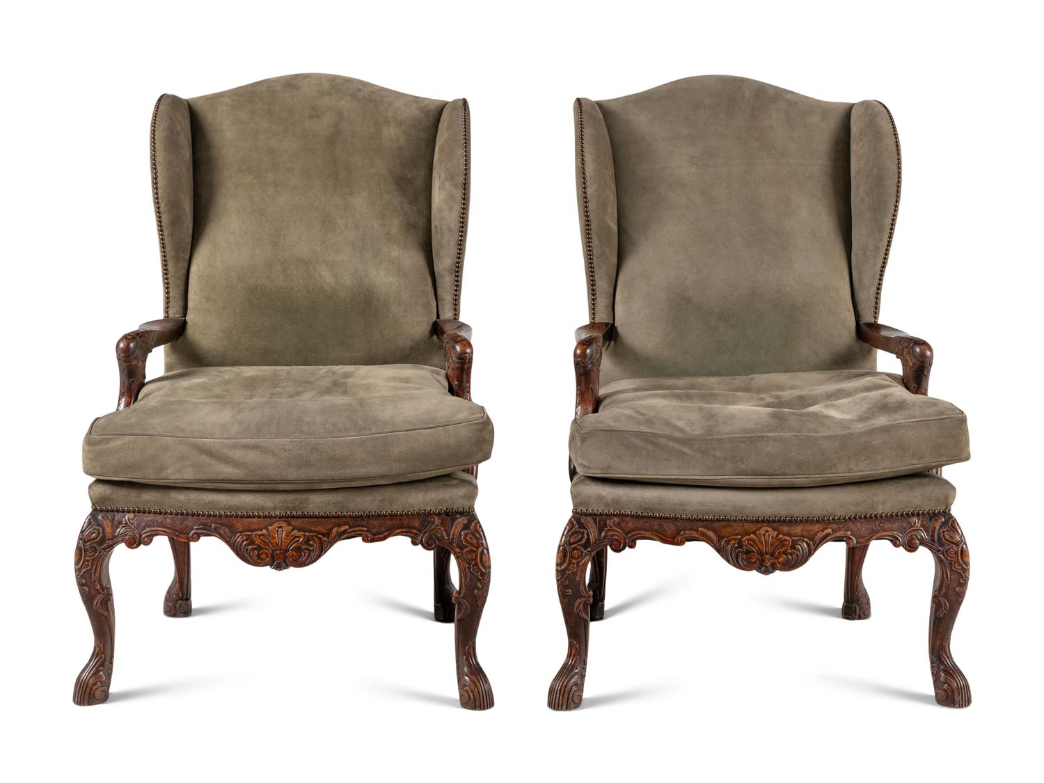 A Pair of Régence Style Suede Upholstered Walnut Wingback Fauteuils