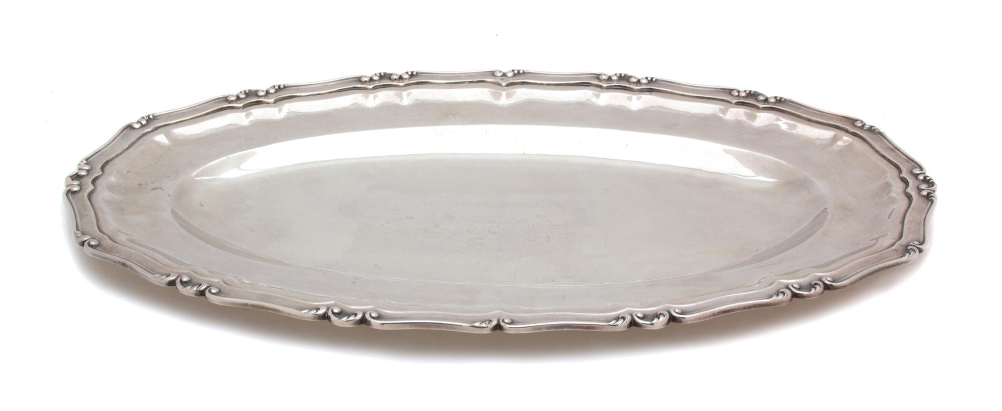 A Peruvian Silver Oval Platter, , having C-scroll border