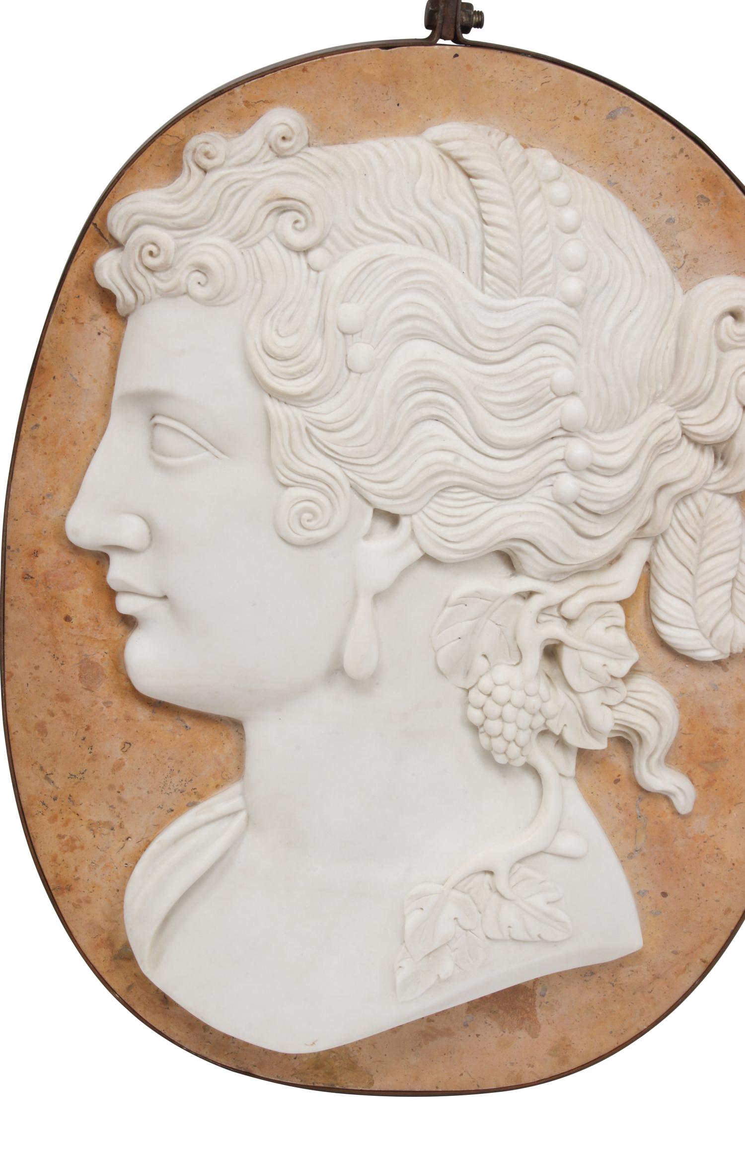A Set of Four Carved Marble and Iron Mounted Profile Plaques
