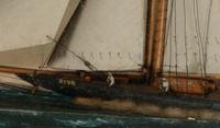 A Carved and Painted Wood Diorama of a Sailboat