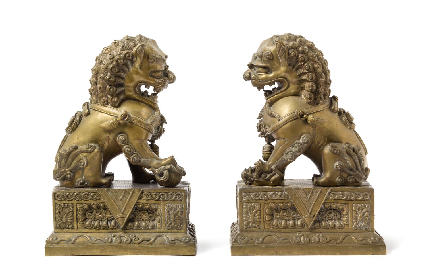 A Pair of Chinese Bronze Fu Lions and Stands 18TH/19TH CENTURY Height overall 14 1/2 inches. — 18TH/19TH CENTURY