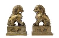 A Pair of Chinese Bronze Fu Lions and Stands 18TH/19TH CENTURY Height overall 14 1/2 inches. — 18TH/19TH CENTURY
