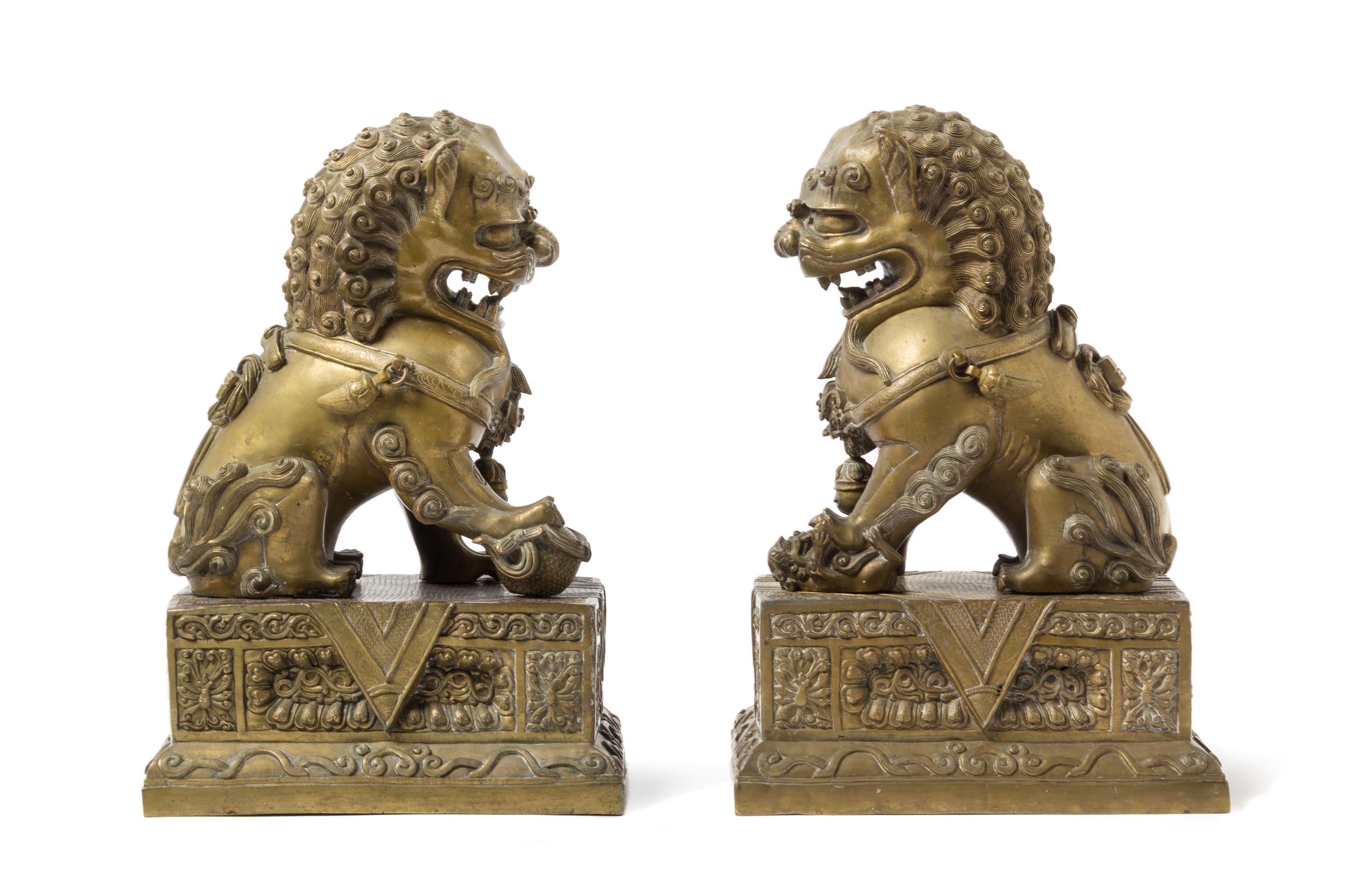 A Pair of Chinese Bronze Fu Lions and Stands 18TH/19TH CENTURY Height overall 14 1/2 inches. — 18TH/19TH CENTURY